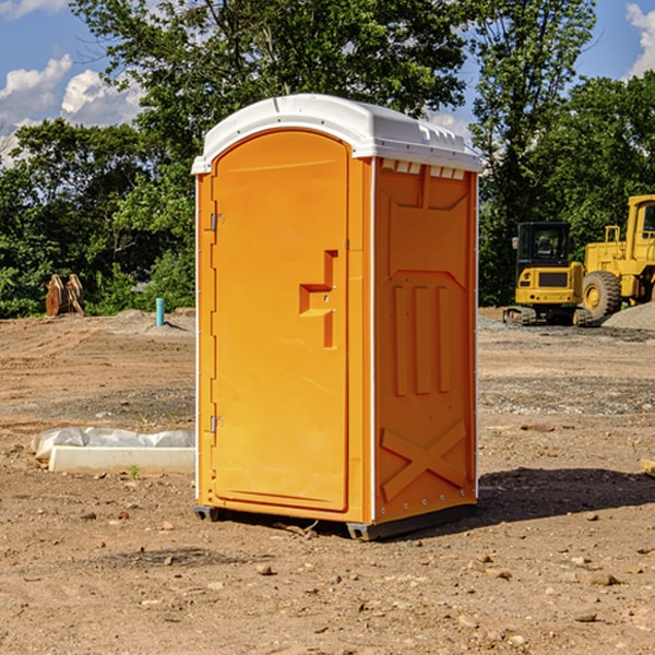 what is the cost difference between standard and deluxe portable toilet rentals in Spirit Lake